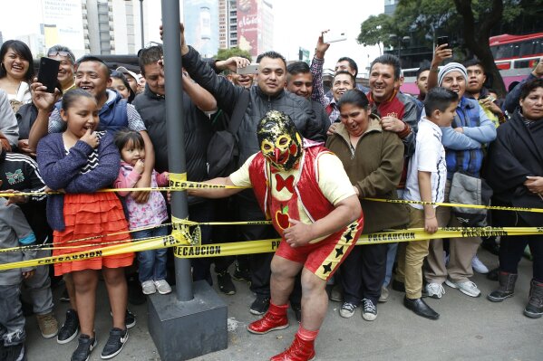 Mexican wrestlers thrill public at historic Metro station | AP News